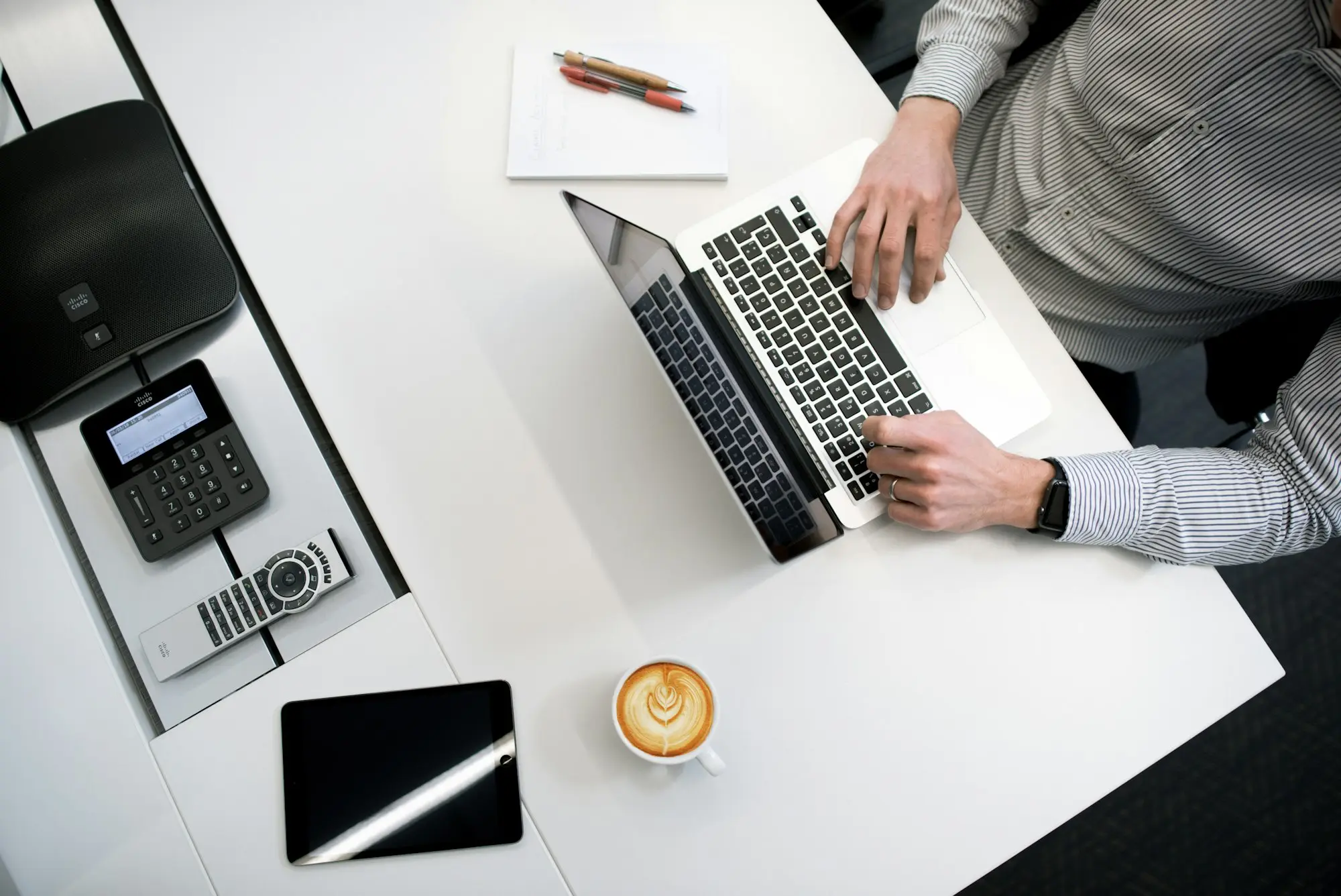 Bookkeeper or accountant at a laptop with fuel receipts and a vehicle logbook