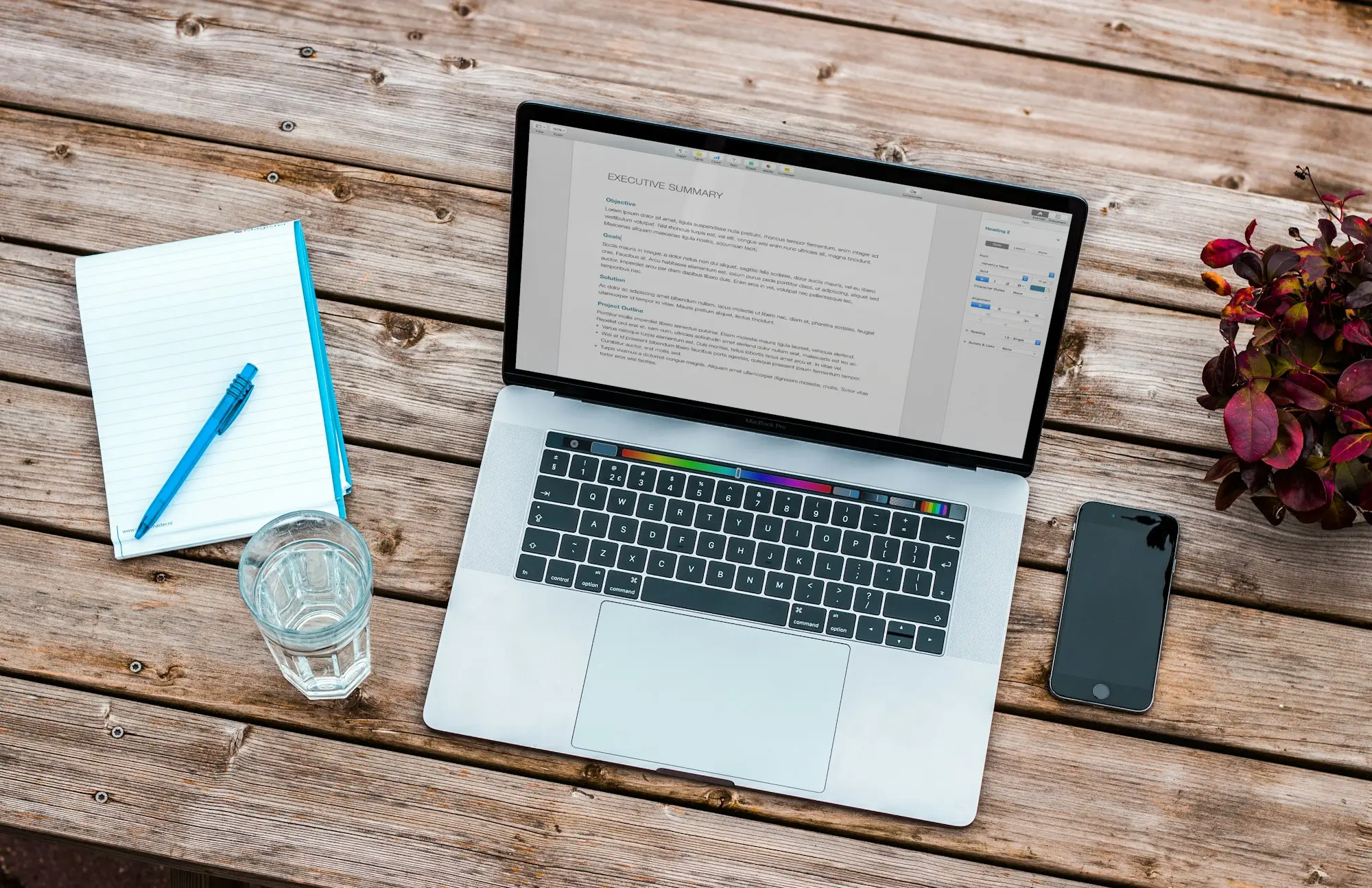 Tidy desk with laptop, document folder, driver licence card (blurred) and car key
