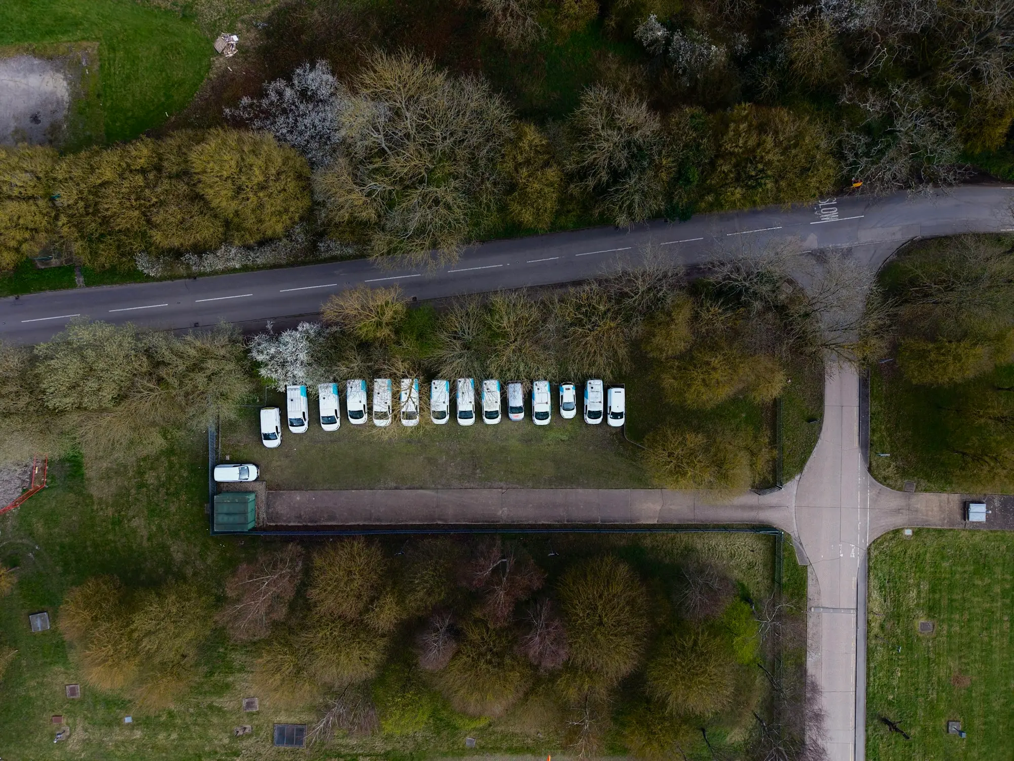 Row of matching white vans at a company depot