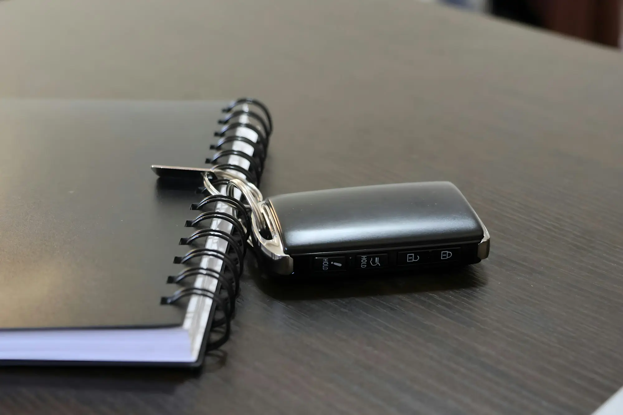 Business owner reviewing documents at a desk with car keys on the table