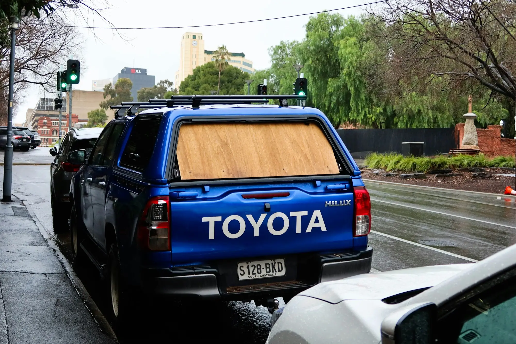 Blue dual-cab ute with a canopy parked kerbside on an Australian street